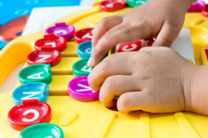 Asian children's Hand  to play alphabet games, Selective focus to Hand